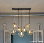Seven-Globe Hanging Light with Adjustable Height Cords for Kitchen Island & Dining Table, Clear Glass Spheres, 35-Inch Canopy, E26 Base, Dim